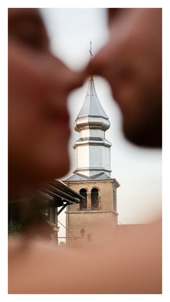 Couple s'embrassant en amorce avec le clocher d'Yvoire en arrière-plan net
